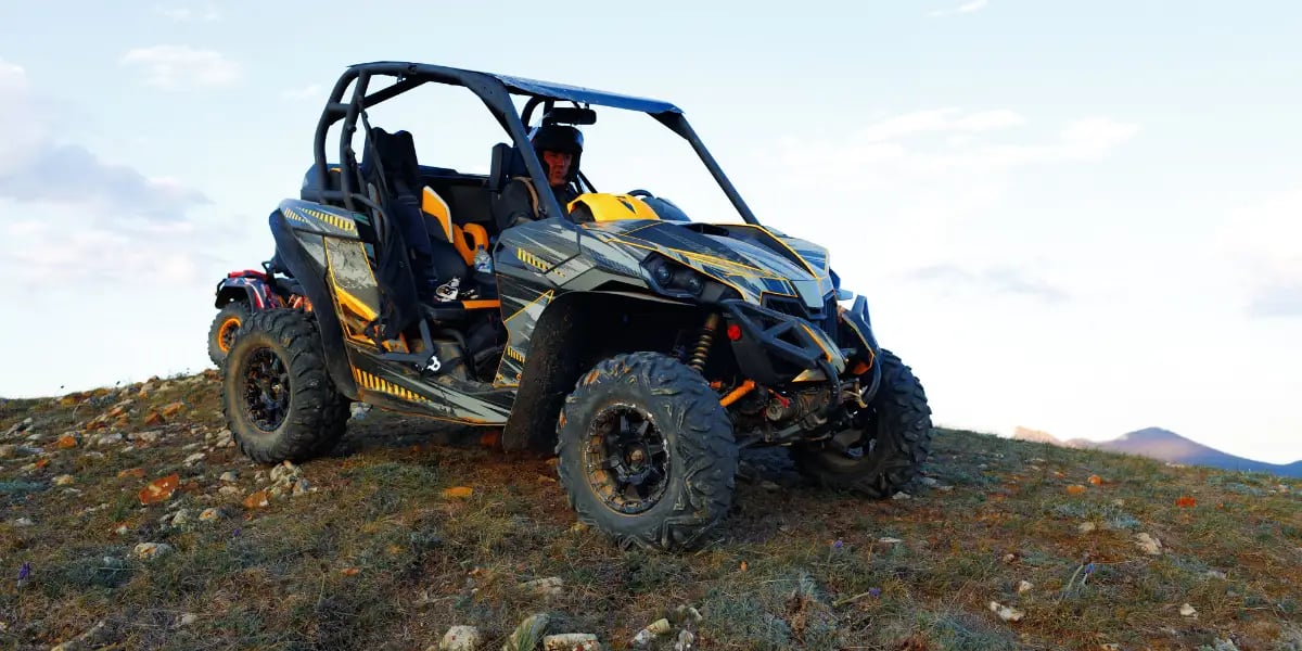 Man Riding a UTV in a Rural Environment