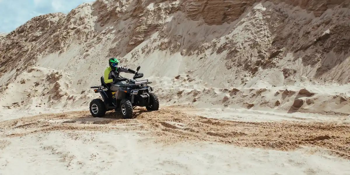 Rider on an ATV Exploring a Sandy Desert