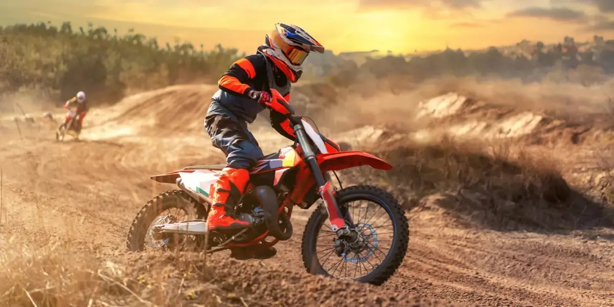 Motocross Rider on Track at Sunrise
