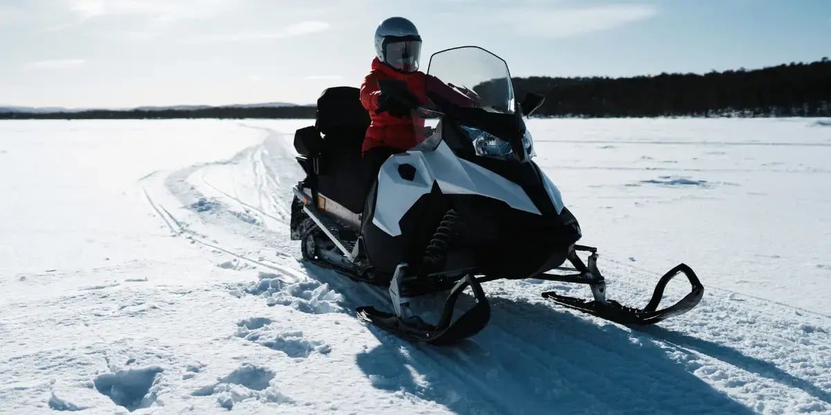 Snowmobile on Snow Covered Ground in Winter